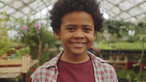 Portrait-of-Happy-African-American-Boy-in-Greenhouse
